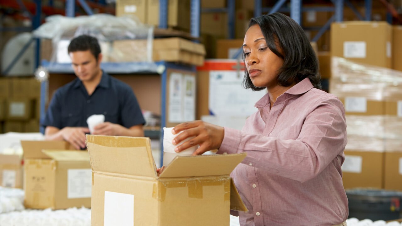 Manager does quality control on assembly line package
